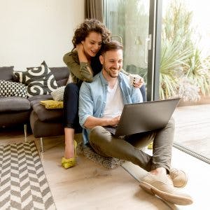 Couple Of Homeowners Checking Their Home Equity Online