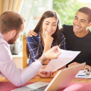 Happy Couple Homeowner Talking To A Financial Advisor About Interest Rates