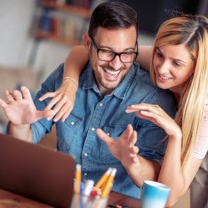 Happy Couple Homeowners Checking Online On Ways To Access Home Equity