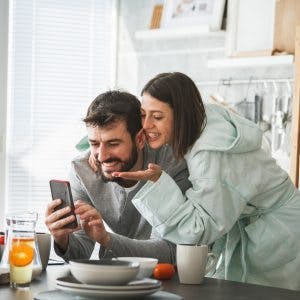 Happy Homeowners Checking Their Credit Score On Mobile