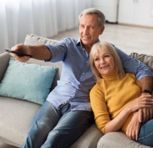 Retired homeowners looking relaxed and happily hanging out after getting a Home Equity Conversion Mortgage or Reverse Mortgage