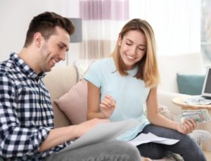 Homeowners looking happy and discussing strategies on how to use their extra cash