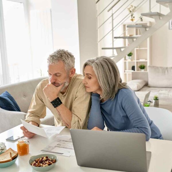 Couples over the age of 55 looking at reverse mortgage documents