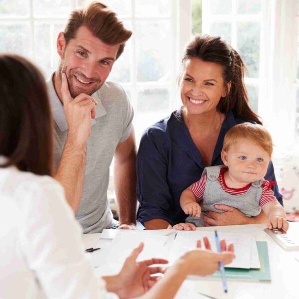 Happy family homeowner discussing the home value of their property with real estate agent