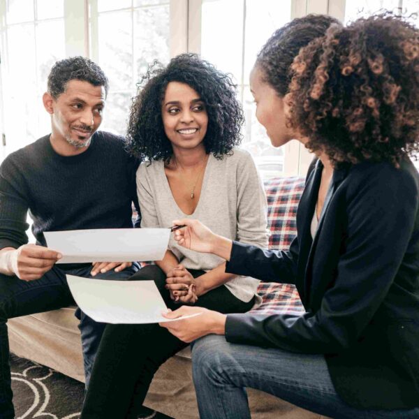 happy homeowners talking to loan officer about documents required mortgage application