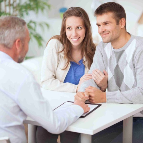 millennial couple talking with lender about refinancing their home