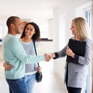 Happy Homeowner Couple Congratulates By Their Underwriter